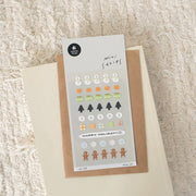 Suatelier Deco.19 Happy Holiday mini sticker sheet with rows of snowmen, Christmas trees, gingerbread men, mugs, and snowflakes, made in South Korea