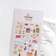 Suatelier Market grocery shopping sticker sheet with illustrated food items including lemons, bacon, eggs, olive oil, pasta, milk, bananas, cookies, and pineapple, made in South Korea