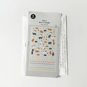 Suatelier Deco Cats sticker sheet with many small orange and black cats, paw prints, fish, stars, and decorative border rows, made in South Korea