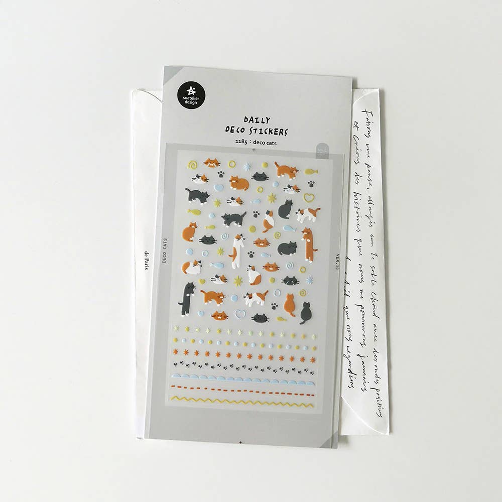 Suatelier Deco Cats sticker sheet with many small orange and black cats, paw prints, fish, stars, and decorative border rows, made in South Korea