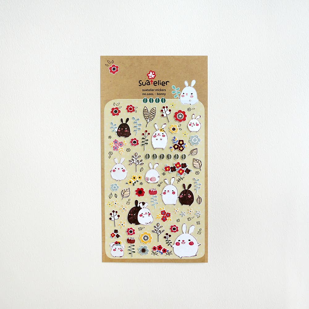 Suatelier Bonny bunny and flower sticker sheet with kawaii round white and brown rabbits among colorful folk flowers on warm yellow background, made in South Korea