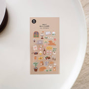 Suatelier Small Happiness cozy daily life deco sticker sheet with illustrated window, lamp, coffee, laptop, poodle dog, steak dinner, wine glasses, and happiness text on warm tan background, made in South Korea