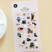 Suatelier Cat's Catch tuxedo cat deco sticker sheet with illustrated black and white cat in daily life scenes including laptop, bed, window, and yarn, made in South Korea