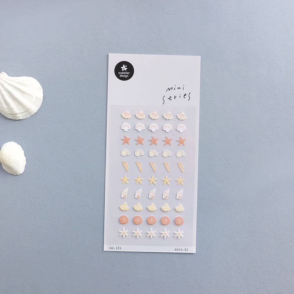 Suatelier Deco.21 seashell mini sticker sheet with rows of shells, starfish, conch shells, and spiral shells in sandy beach tones on light blue background, made in South Korea